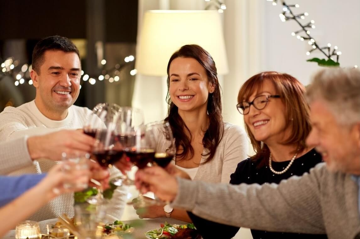 host and guests toasting one another at a celebration meal